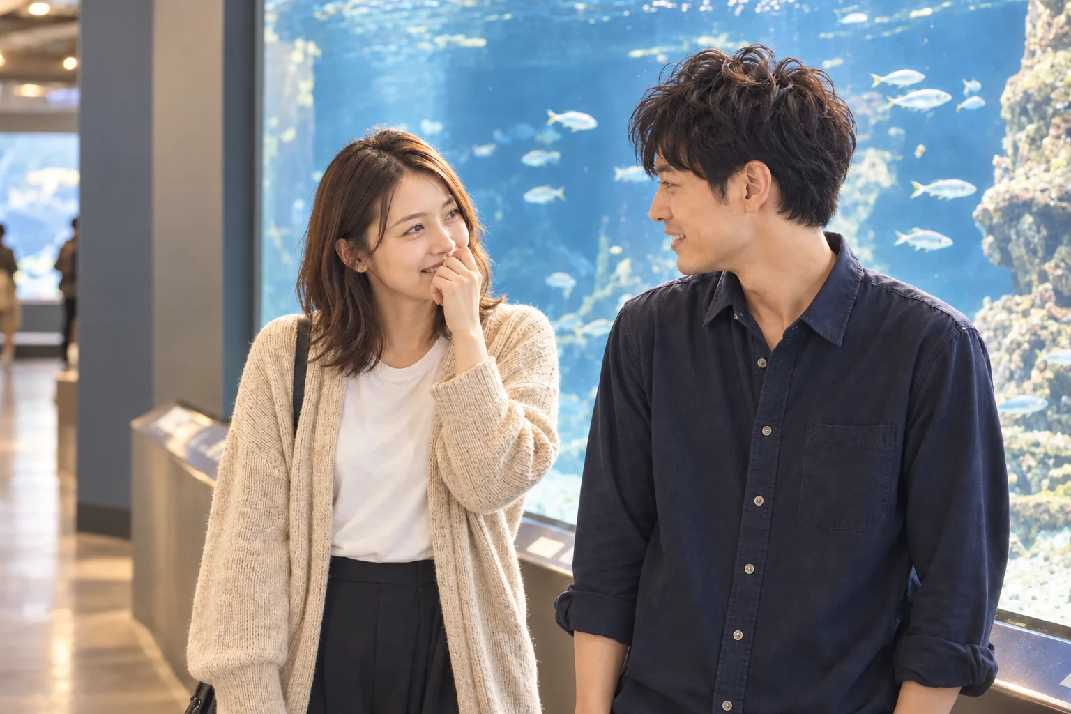 初デートの水族館で、泳ぐ魚を見ながら笑顔を交わすふたり。AI生成のイメージ